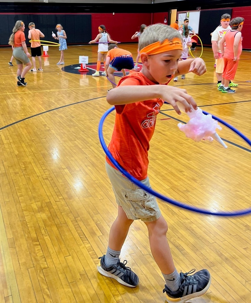 3rd grader hulahoops while eating cotton candy