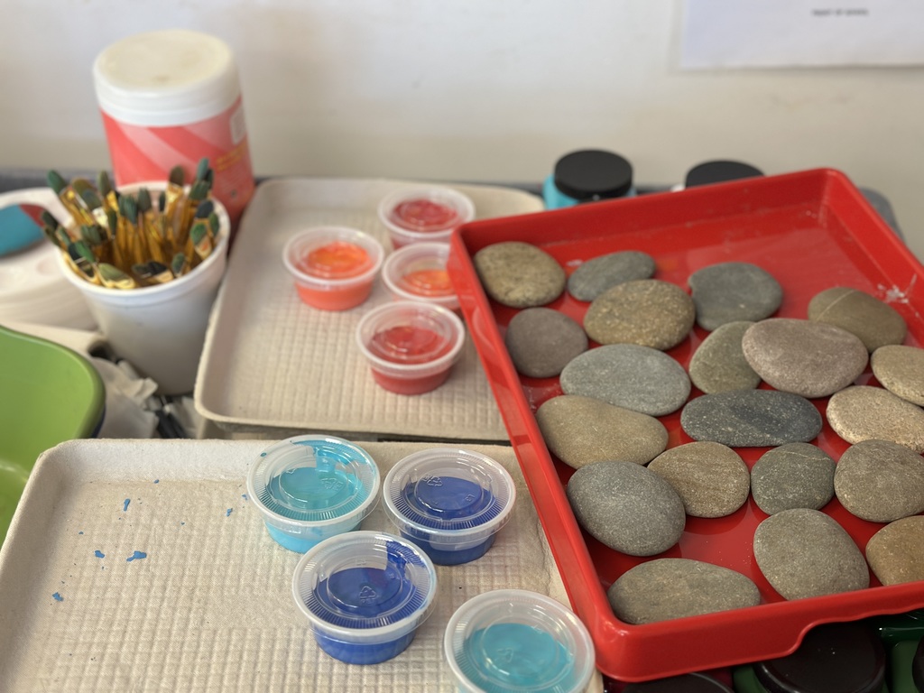 river rocks, paint, and paint brushes