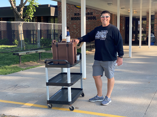 Nate Carlson serving coffee out from the middle school