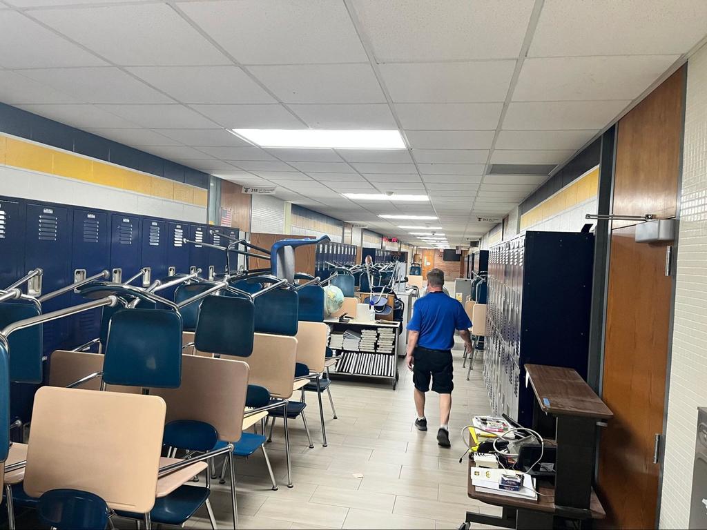 Custodian walking down the hall