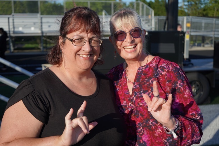 sign language interpreters sign I Love You at graduation