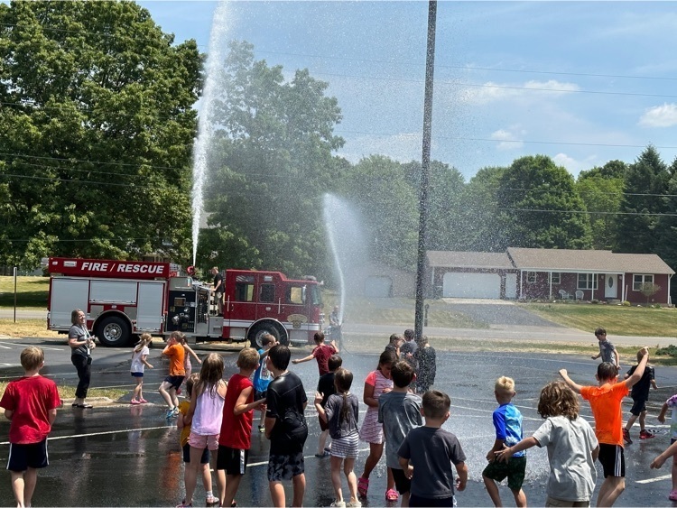 cooper students playing in water from a fire truck