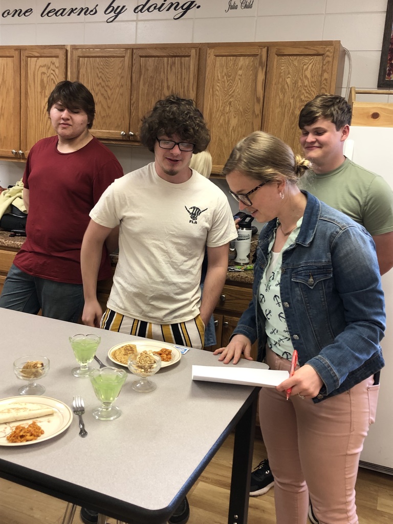 Student showing food to staff member