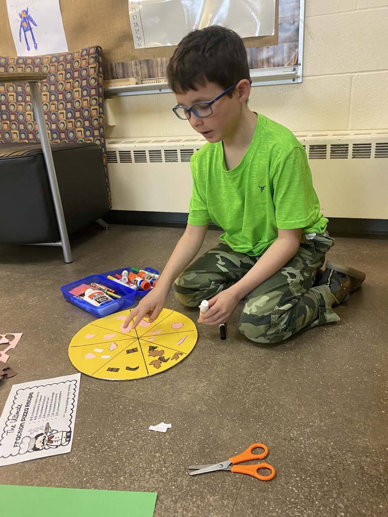 Student working on assembling pizza