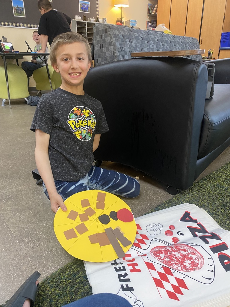 Student with pizza and smiling