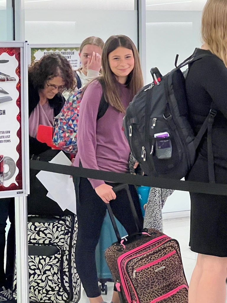 Mrs. Busch, Ava Miller and Maelys Beachy going through airport security