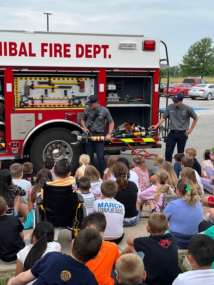 students watching firemen during presentation