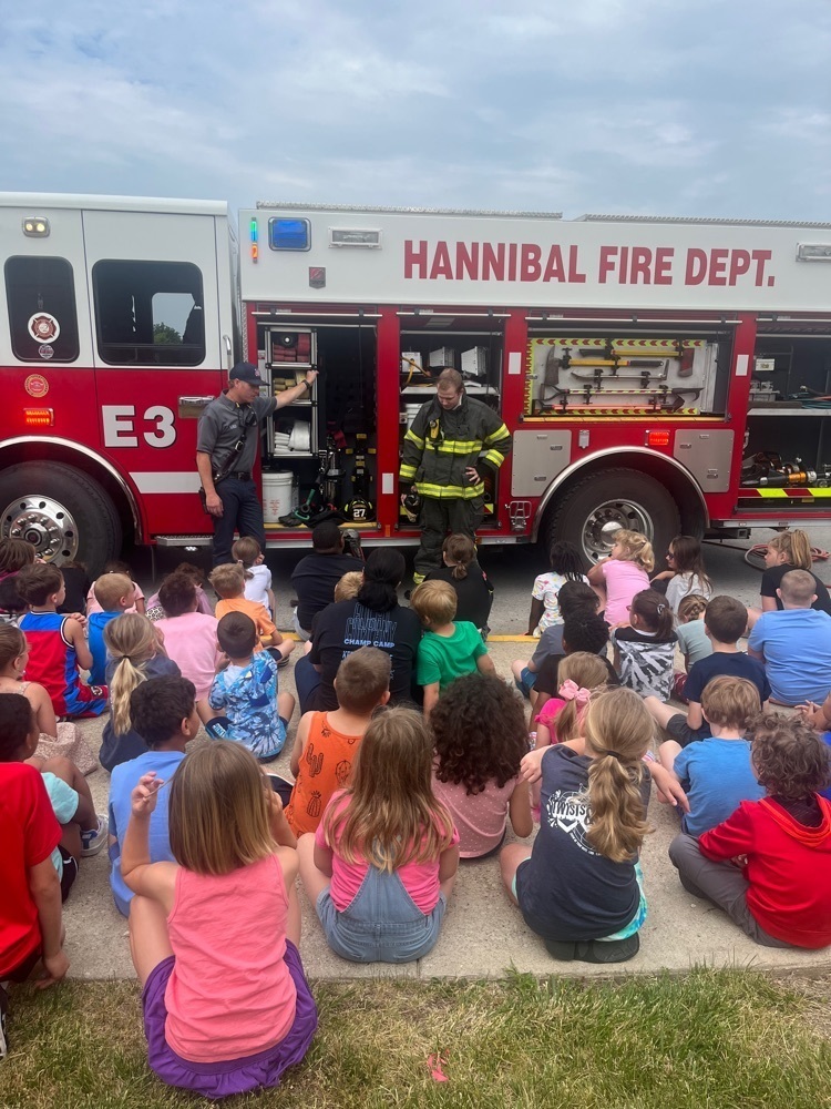 students watching firemen during presentation