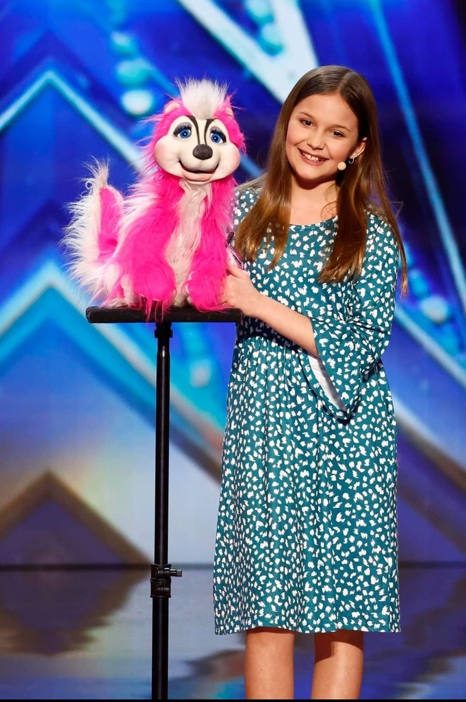 paw paw middle school student holding puppet