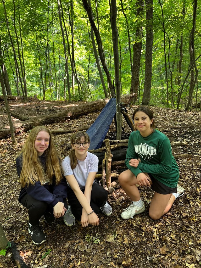 students smile by tent