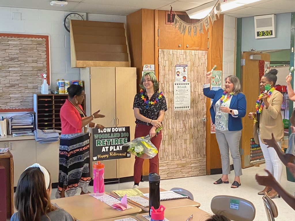 People cheer for a Woodland retiree in her classroom