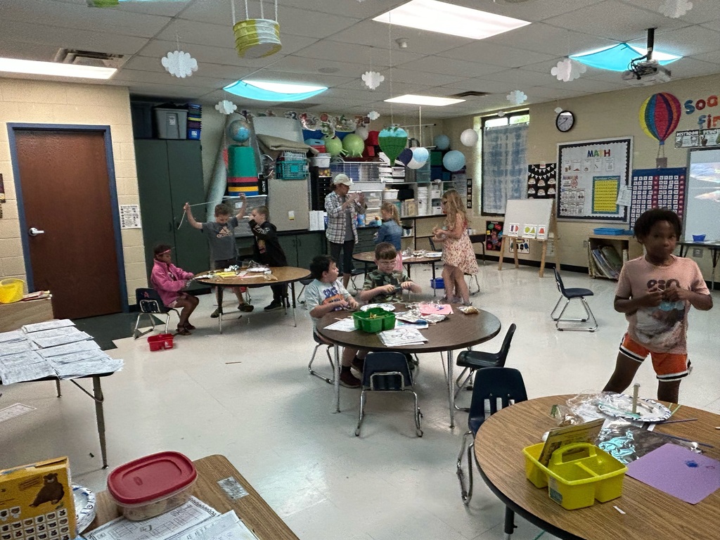students build model tents at tables