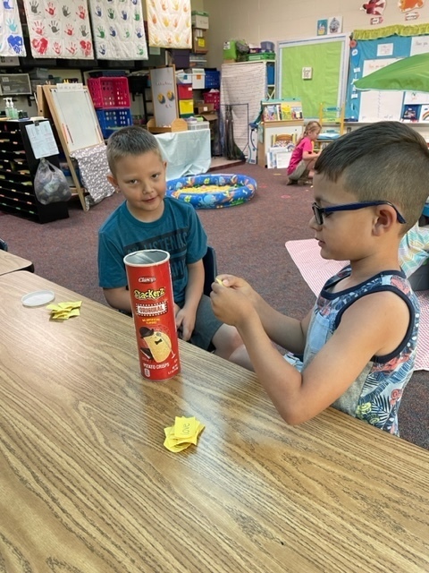 students holding yellow flash cards