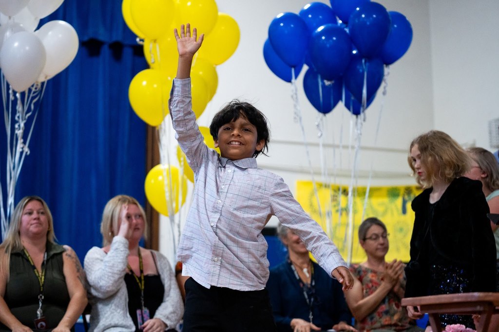 student waving