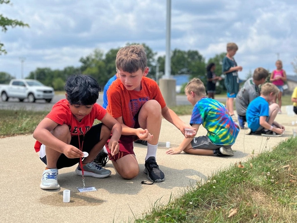 two boys work on rockets