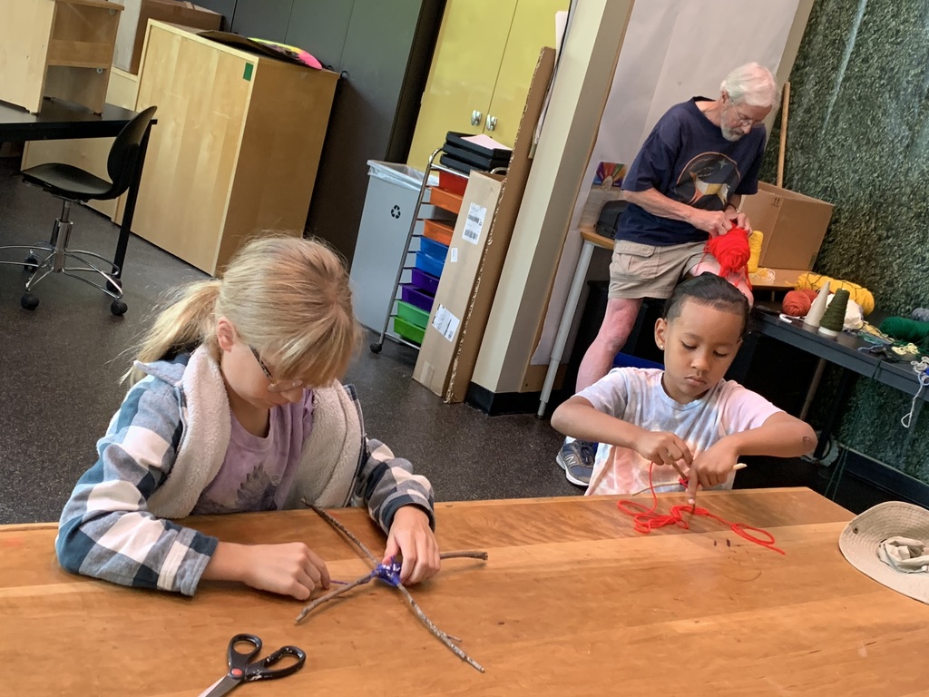 Students creating a yarn and branch project in the art classroom.
