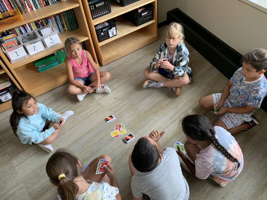 Students playing Uno inside their classroom.