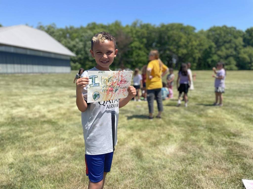Student showing his bubble art for Mother Earth.