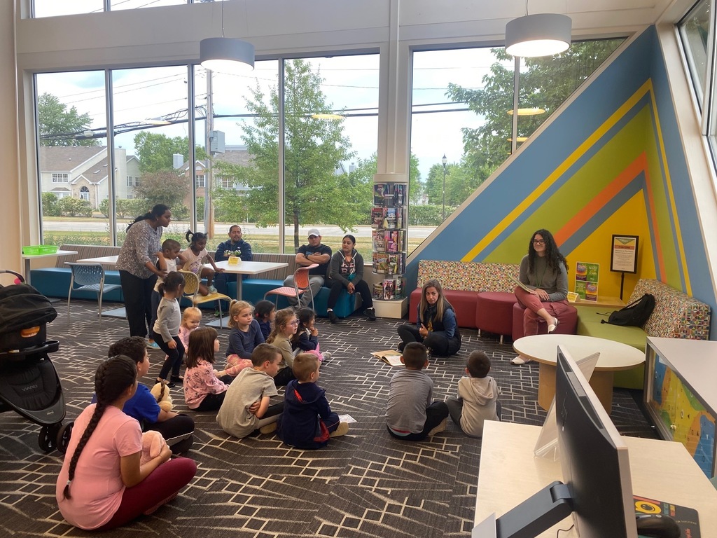A Woodland teacher reads a story to a group of children