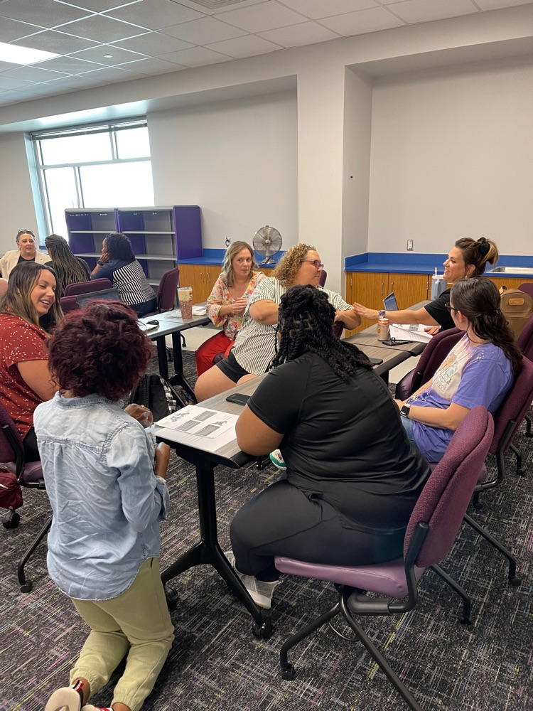 A group of staff and parents having a discussion