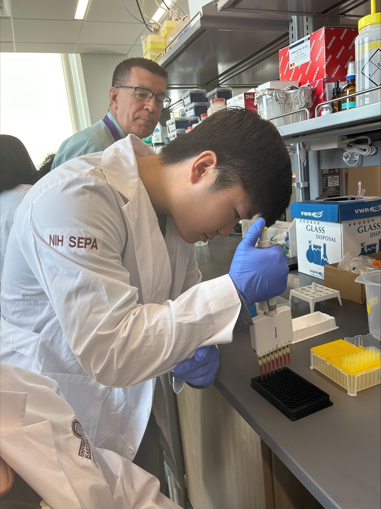 student putting droplets into a tray