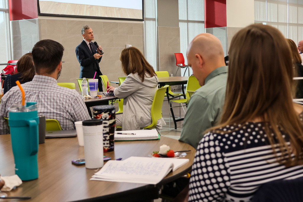 administrators listening to Dr. Rhodes