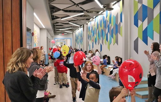 Student and teachers in a school corridor