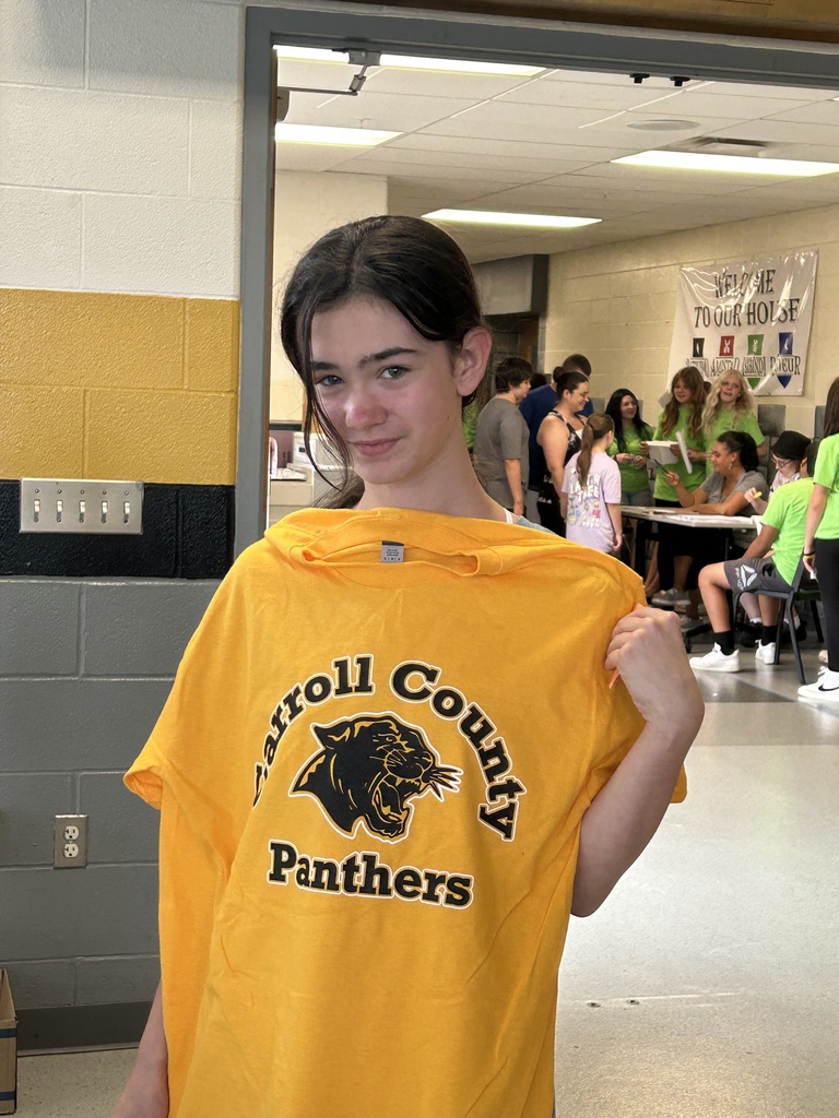 Student showing new CC shirt