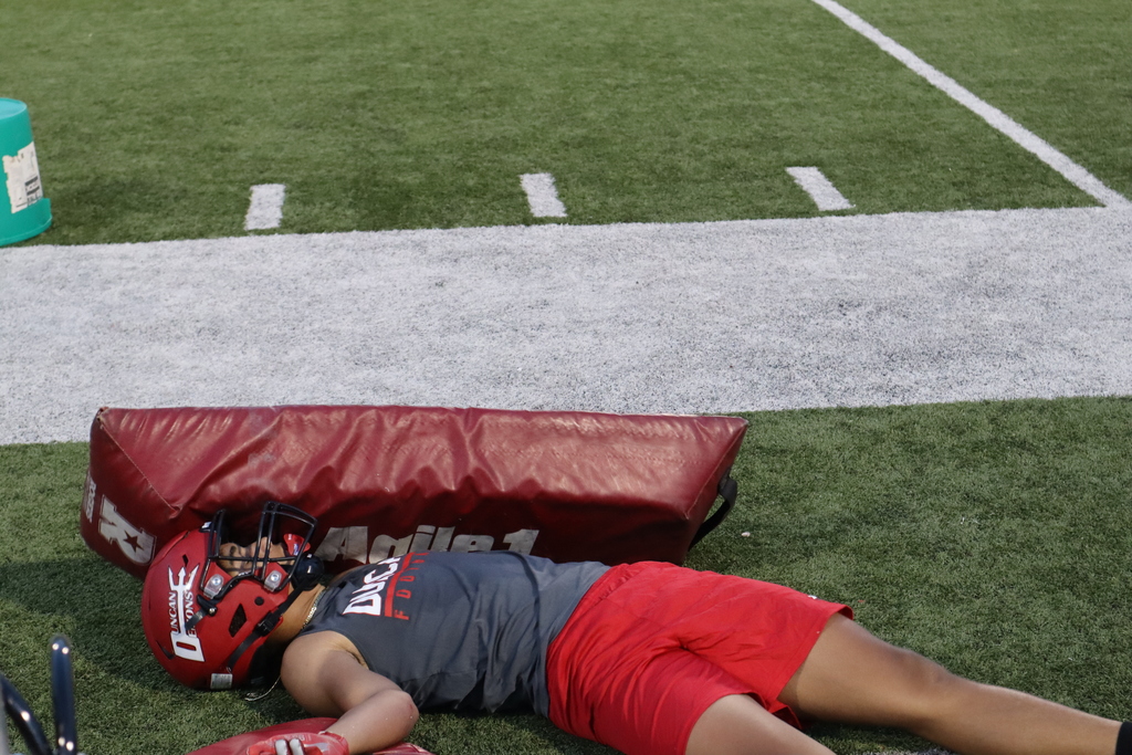 Duncan Demon football player laying on his back