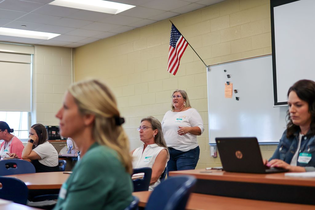 a woman teaches in a classroom