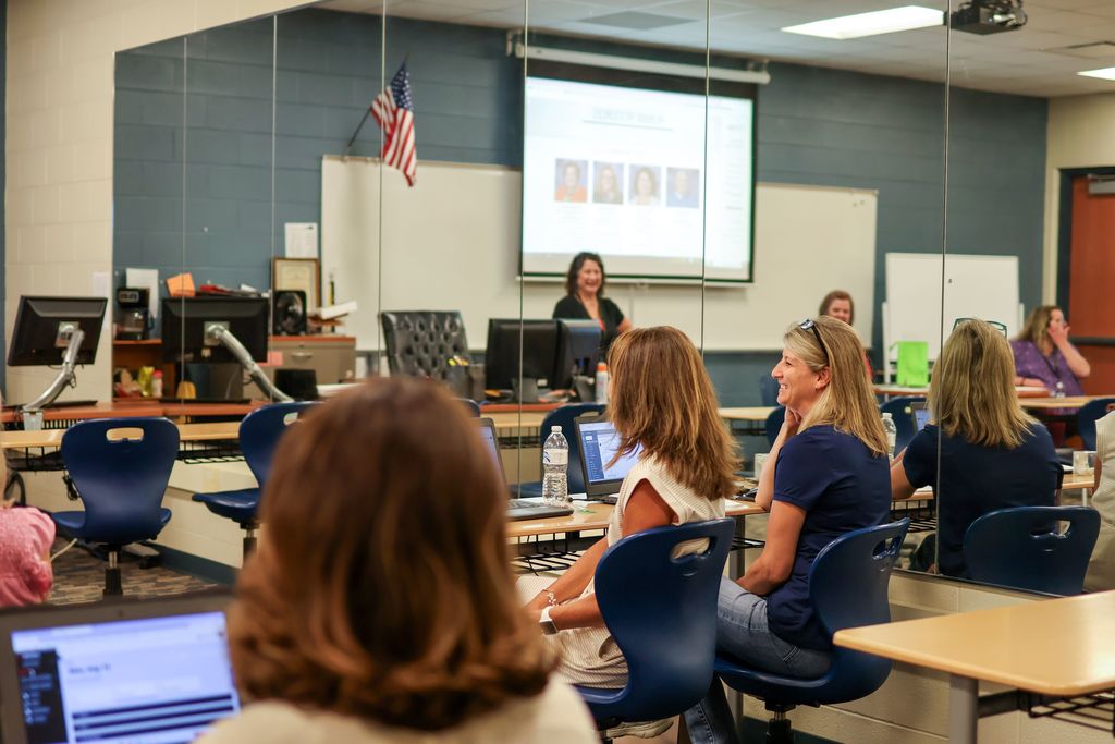 women at desks in a classroom
