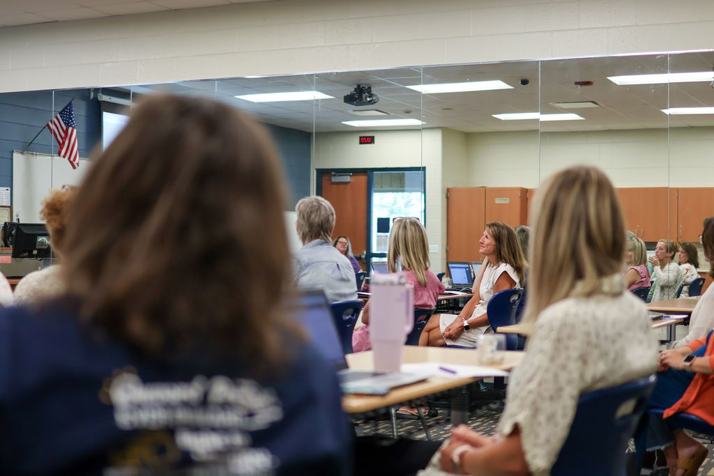women at desks in a classroom