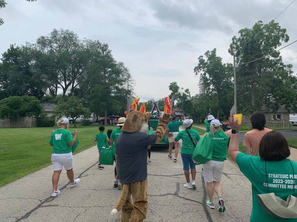 Woodland volunteers wave during the parade