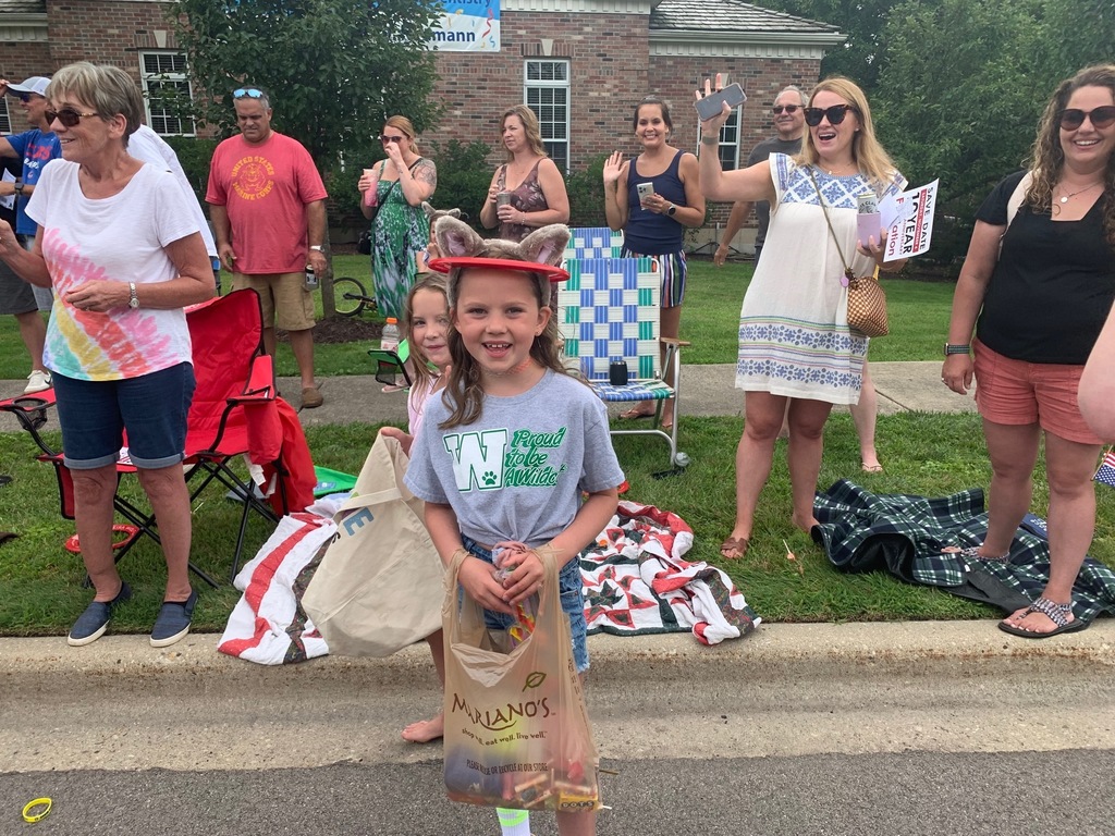 A young girl wearing Woodland spirit wear along the parade route