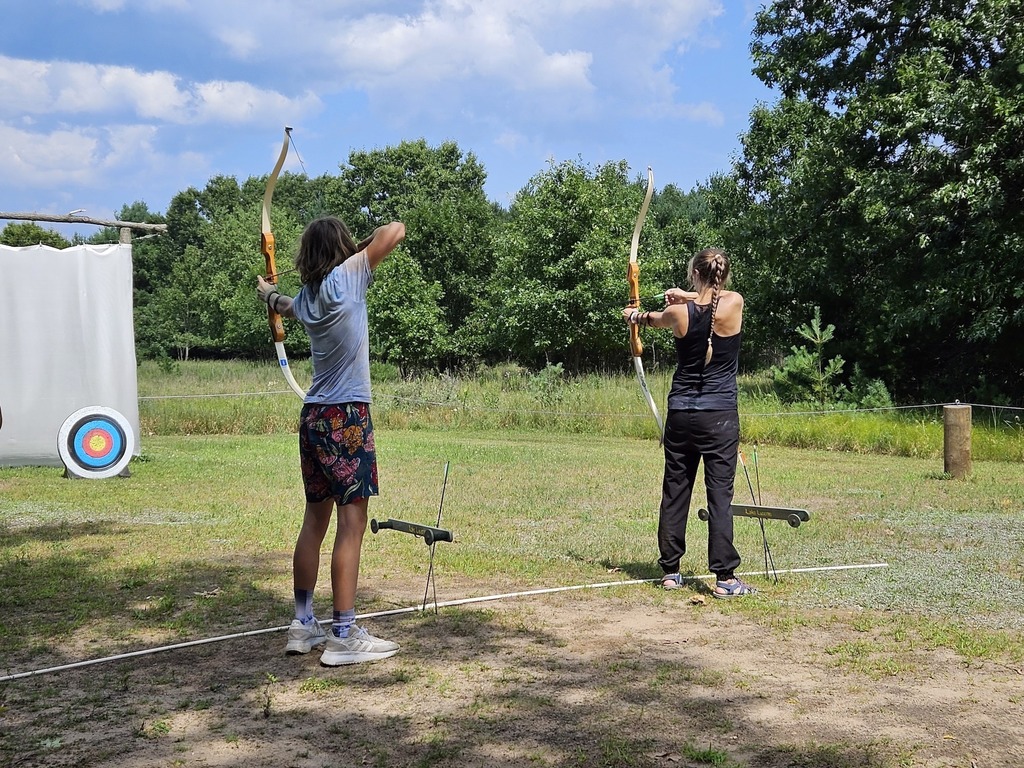 Mother and son doing archery.