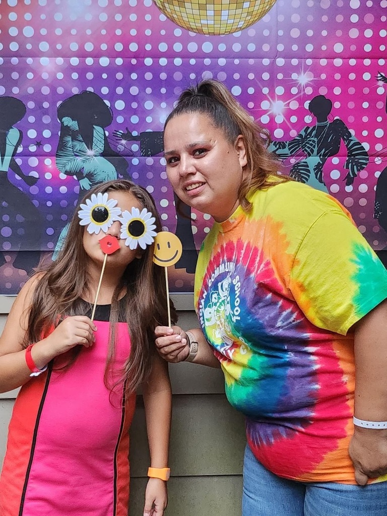 Mother and daughter in 70's clothing.