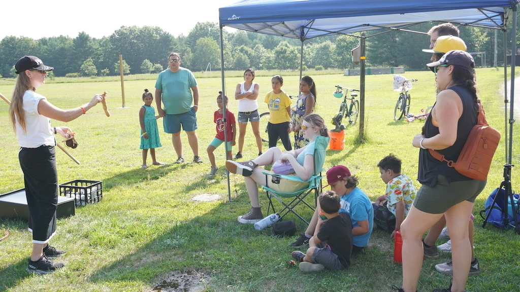 Teacher showing families how to play double ball.