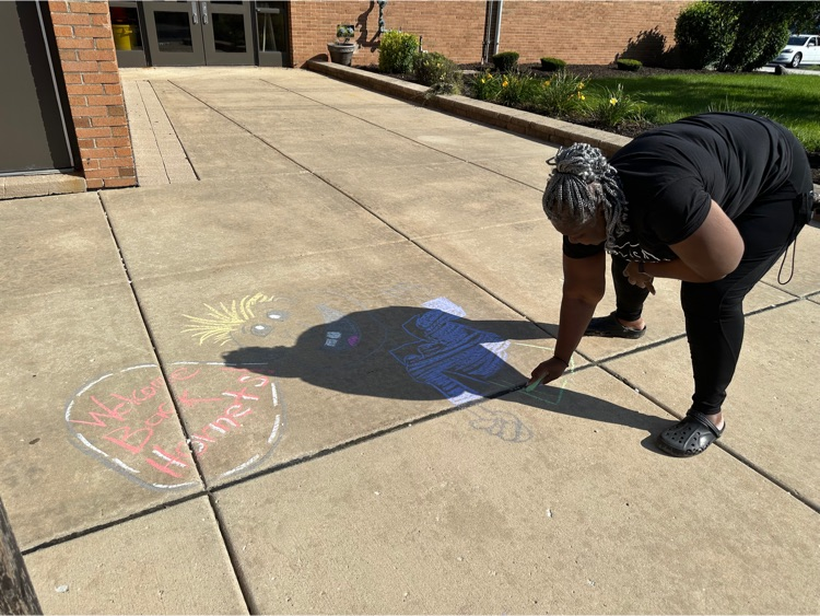 teacher chalks the walk for students 