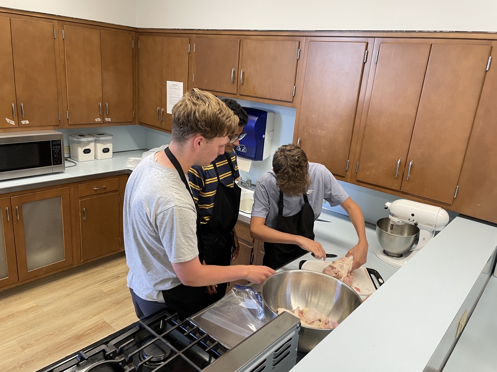 students cooking in a classroom cooking lab