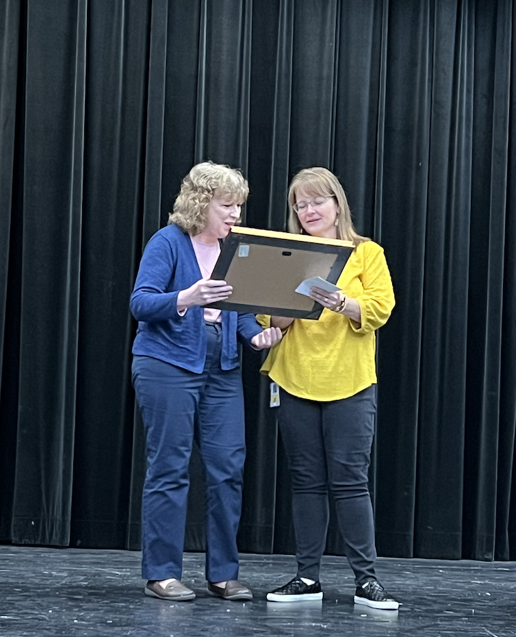 Cindy Malichky and Carmela Ulin presenting her painting