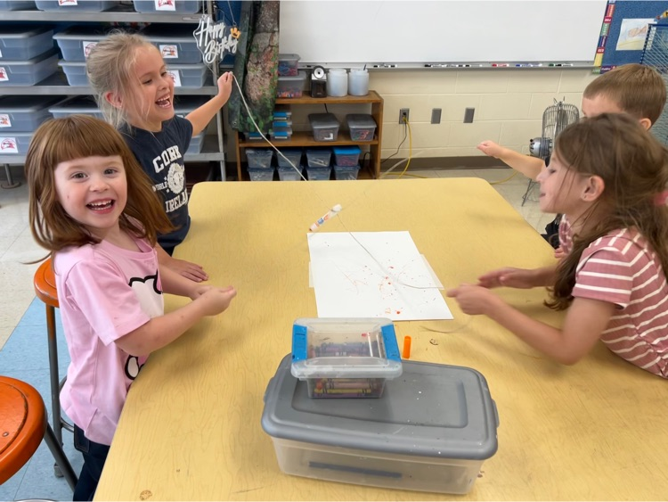 During Exploratories today Kindergarten worked together to try to draw a smile with a marker. The catch? They could only move the marker using the string! Loads of laughs & communication practice! #HESRedHawks