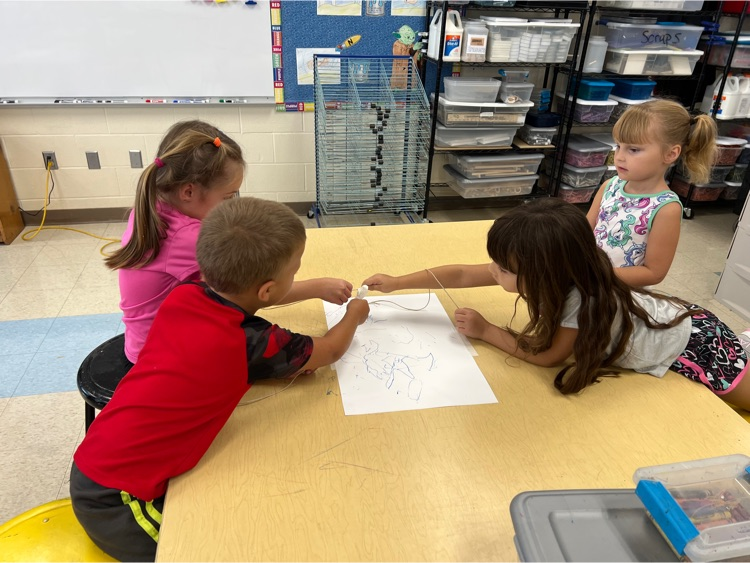 During Exploratories today Kindergarten worked together to try to draw a smile with a marker. The catch? They could only move the marker using the string! Loads of laughs & communication practice! #HESRedHawks