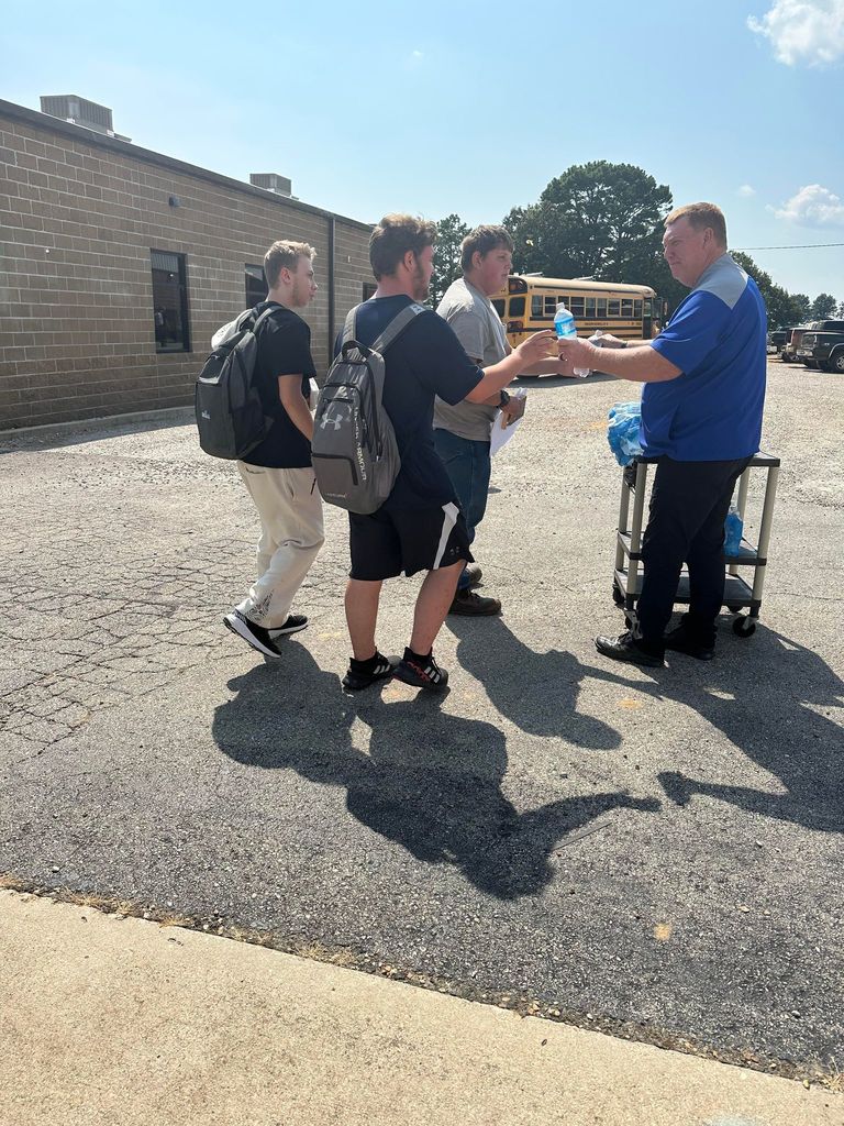 Mills Excavating donated water bottles for district bus riders.