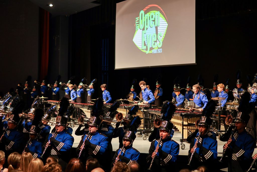 a marching band performs in an auditorium