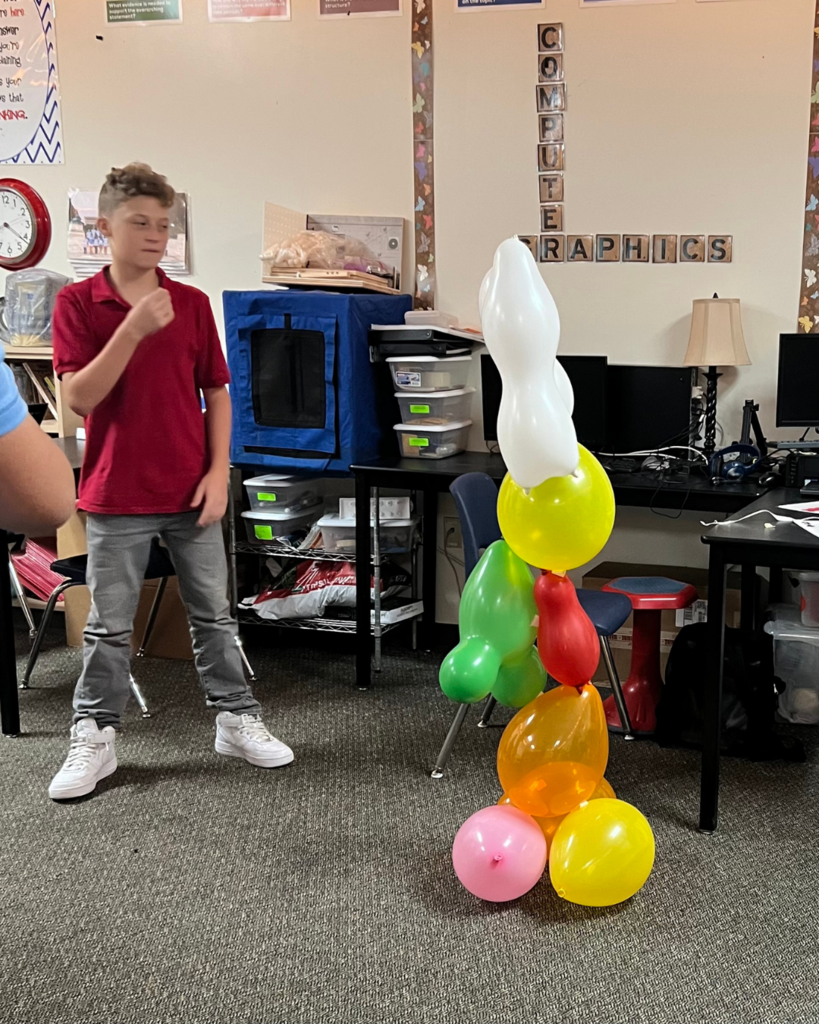 student watching his tower to see if it is stable