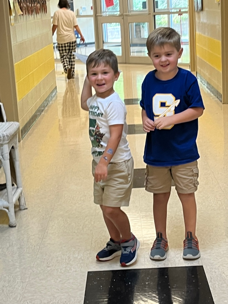 Students fly paper airplanes. 