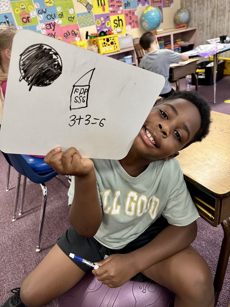 2nd grade student and their math work