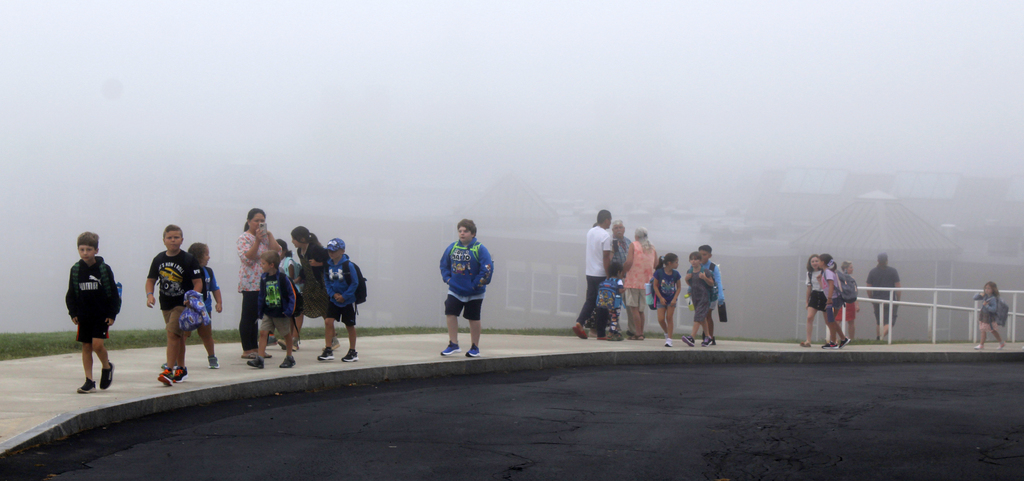 Children walking up the sidewalk