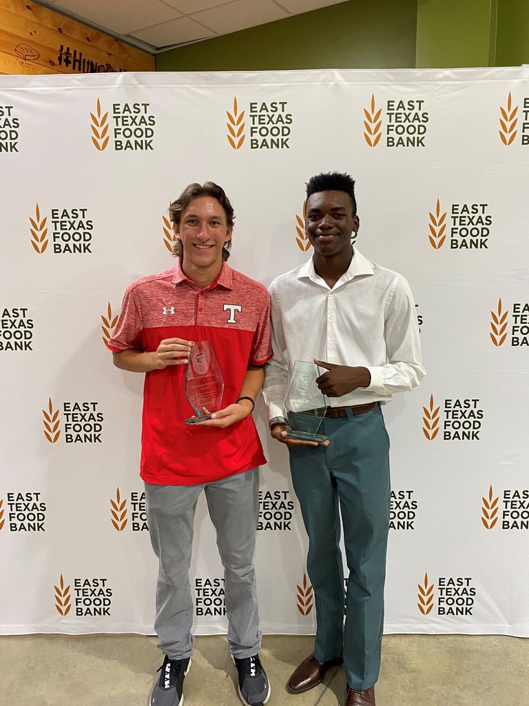students holding award