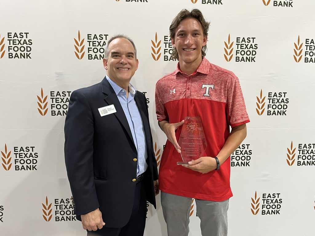 Tyler Legacy High School student standing with ETFB rep with award.